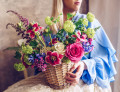 Young Woman with a Basket of Flowers