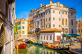 Narrow Canal with Gondolas In Venice