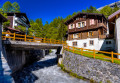 River and Chalets in a Swiss Village in the Alps