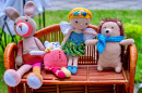 Handmade Crochet Toys on a Wicker Bench