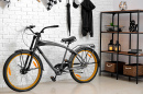 Black Bicycle in a Room with Light Brick Wall