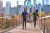 Young Family Walking on a Pedestrian Bridge