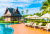 Umbrellas and Sun Loungers around an Outdoor Pool