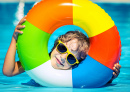 A Happy Child Plays in the Pool