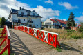 A Wooden Bridge over a River in Leba, Poland